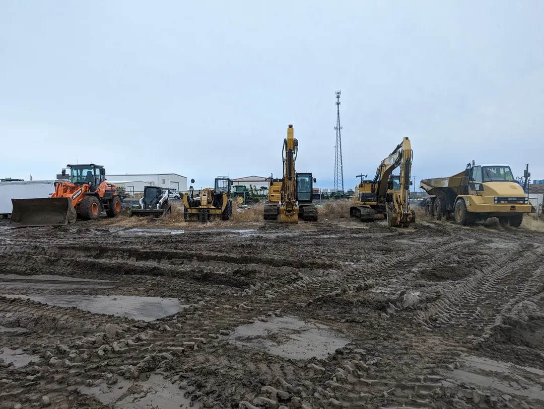 A line-up of Dimond Excavation equipment: wheel loader, skid steer, telehandler, excavators, and an articulated dump truck, staged at the yard